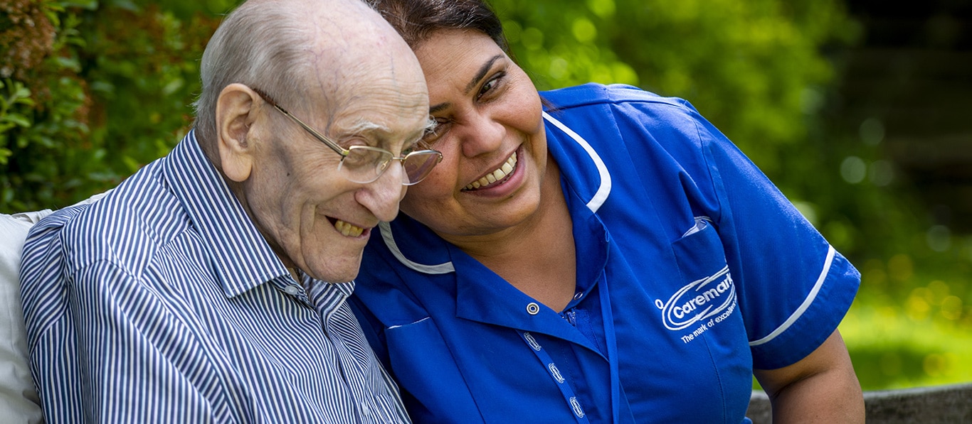 Elderly man with care assistant