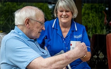 Elderly man and care assistant