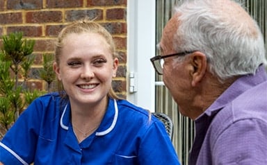 Elderly man and care assistant