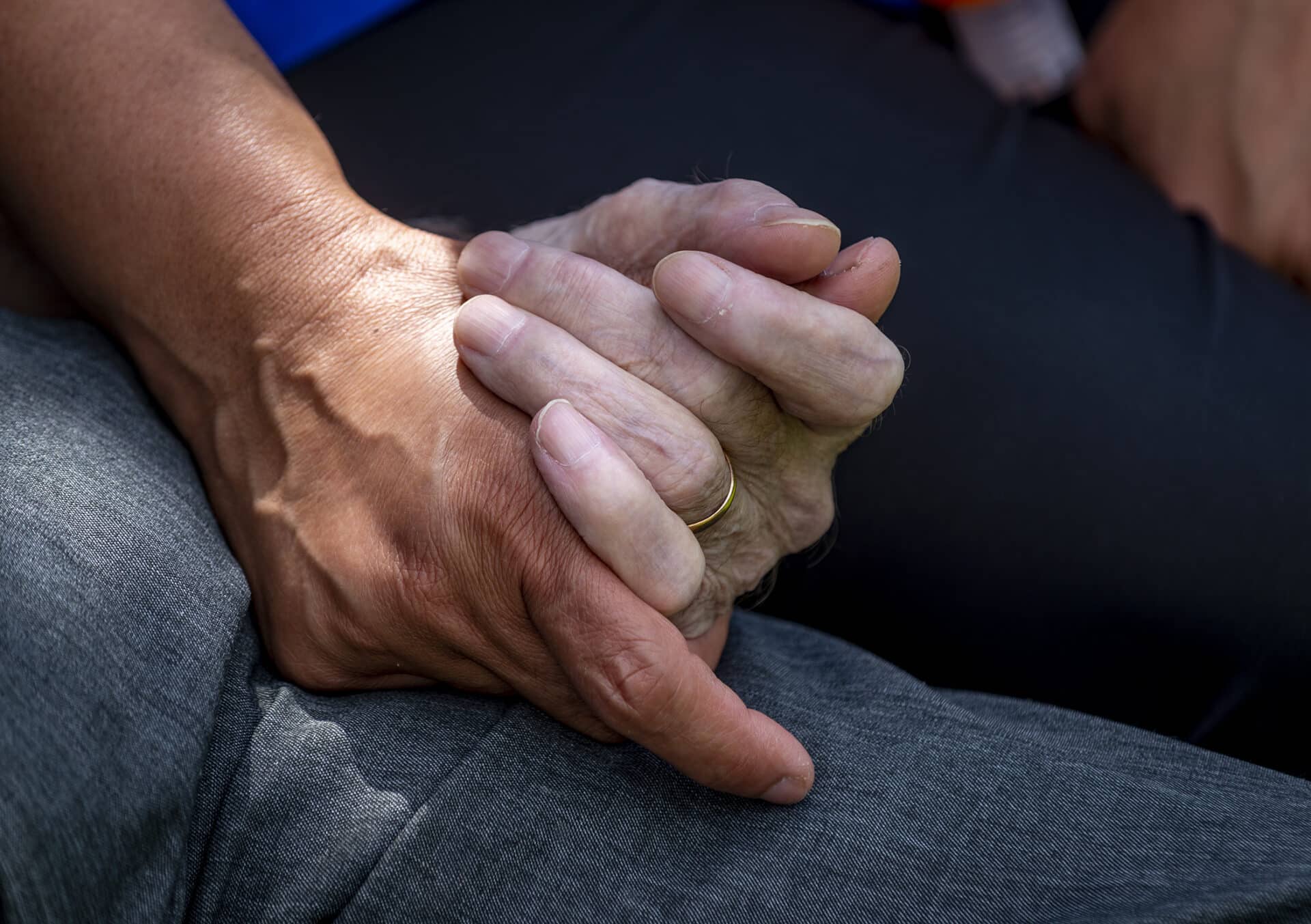 care assistant and customer holding hands