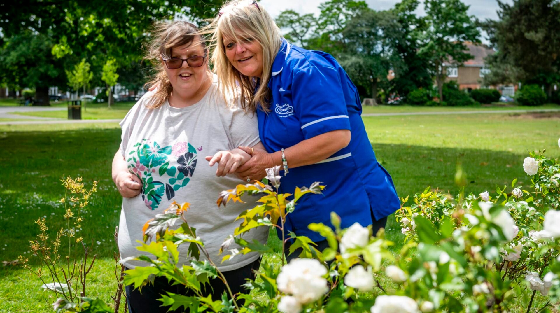 Care assistant and customer in the garden