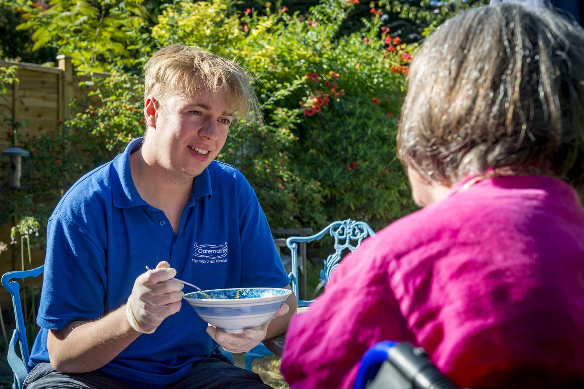 Care assistant giving food