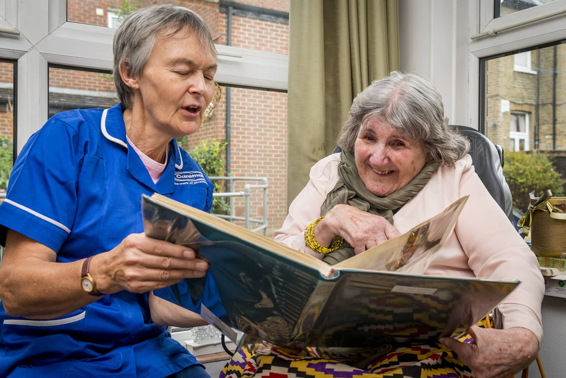 Care assistant reading a book