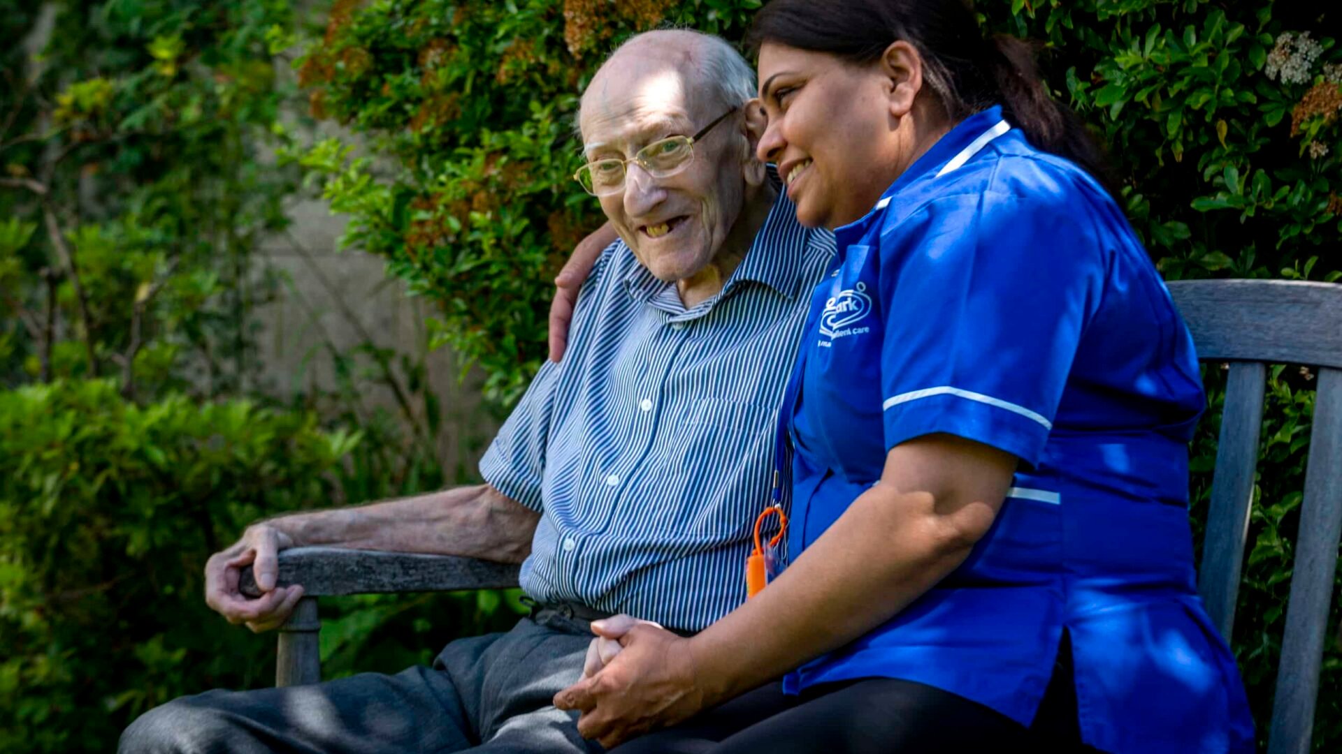 Care assistant hugging customer