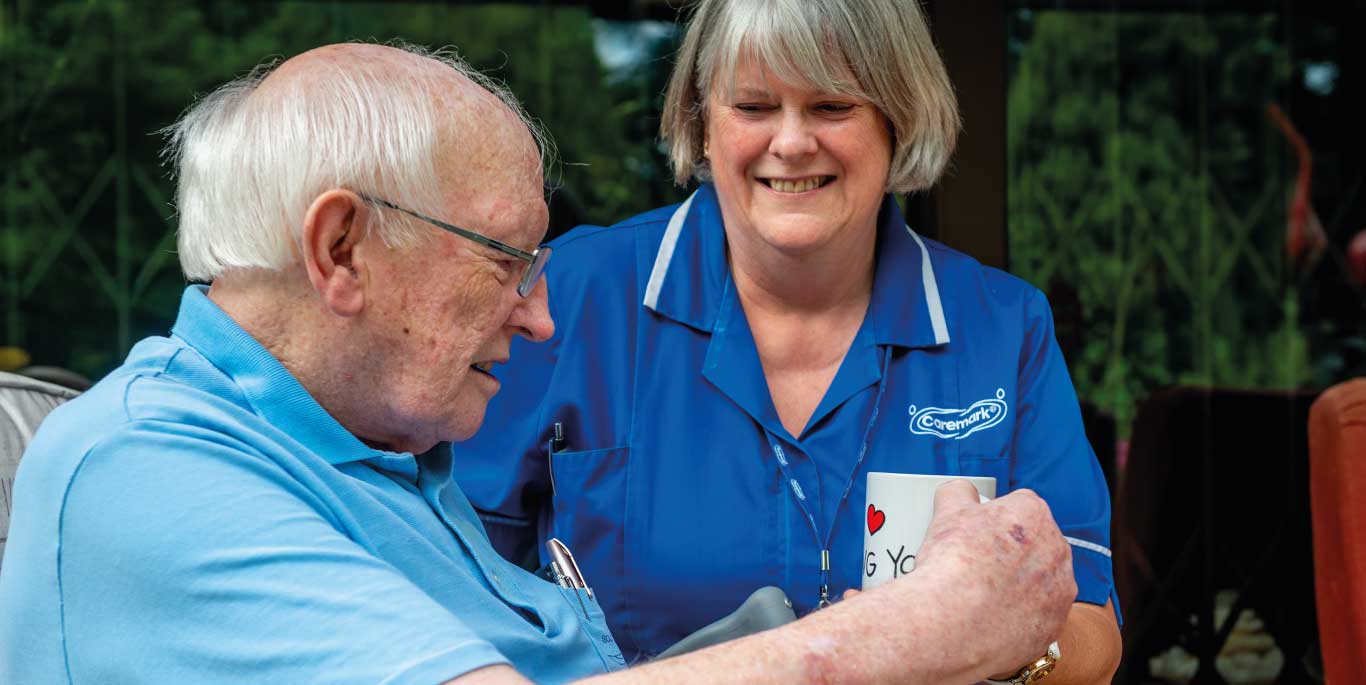 Care assistant handling cup of tea