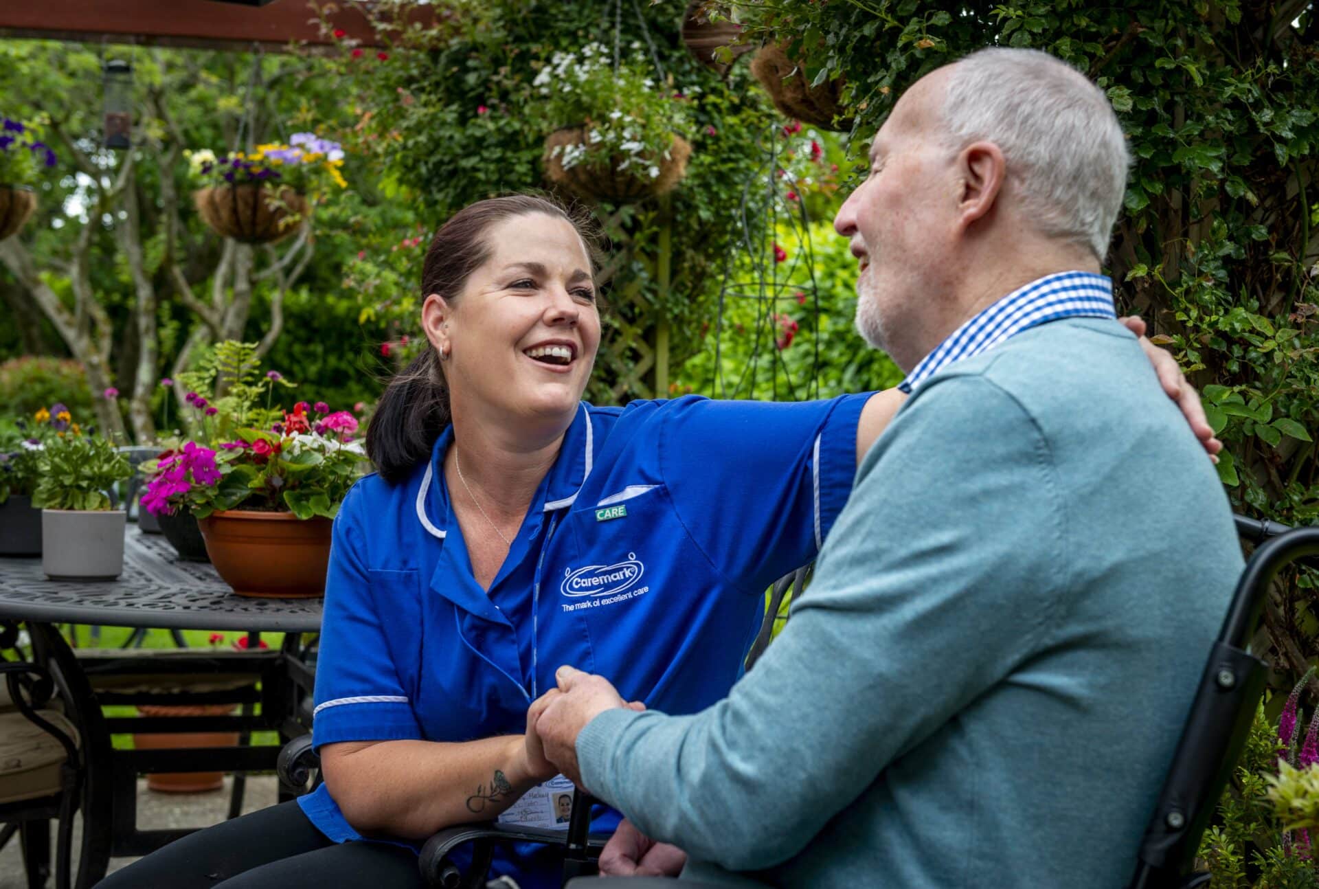 smiling customer in a garden with female care assistant