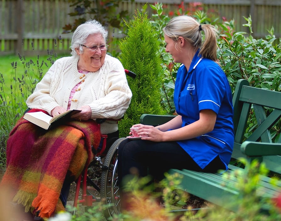 Care in the home elderly lady in garden with care assistant by Caremark in the areas of Beeston, Stapleford, Bramcote, Eastwood, Kimberley & Nuthall