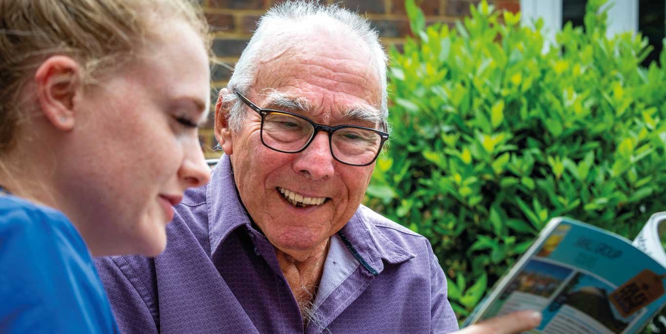 elderly care: companionship service, care assistant reading to customer