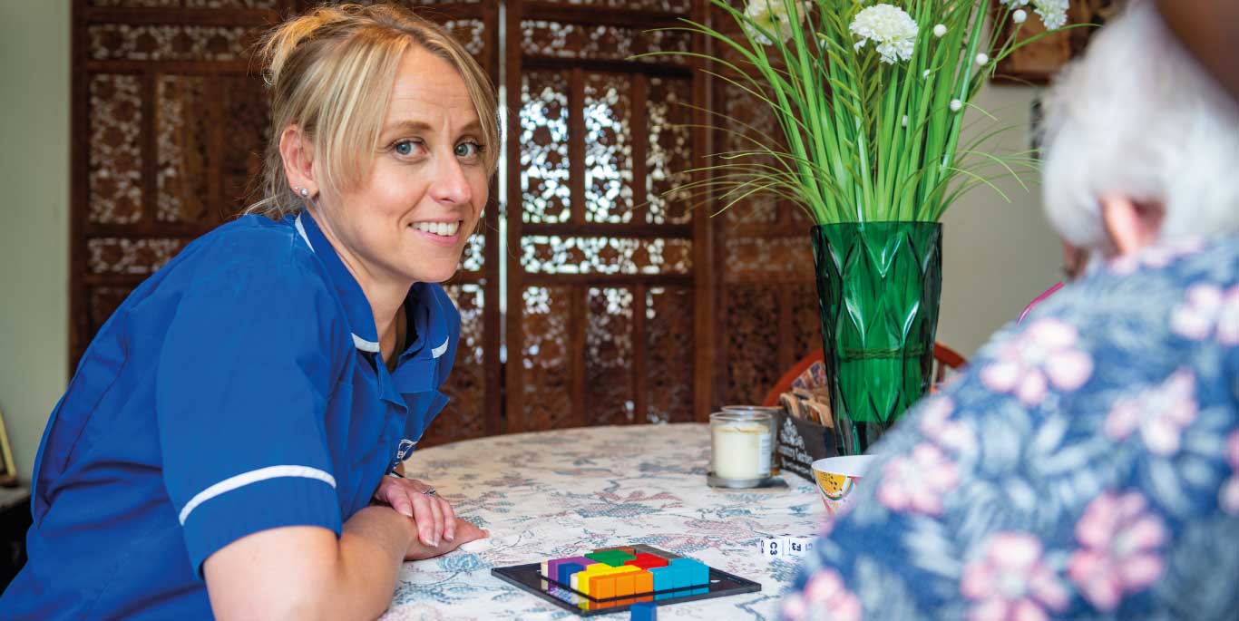 Companionship Care in Stratford Upon Avon : female care assistant and female customer playing a game