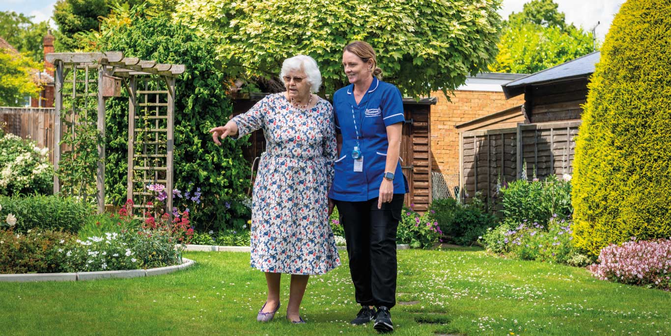 Personal care in Barnsley: female customer and care assistant in garden walking