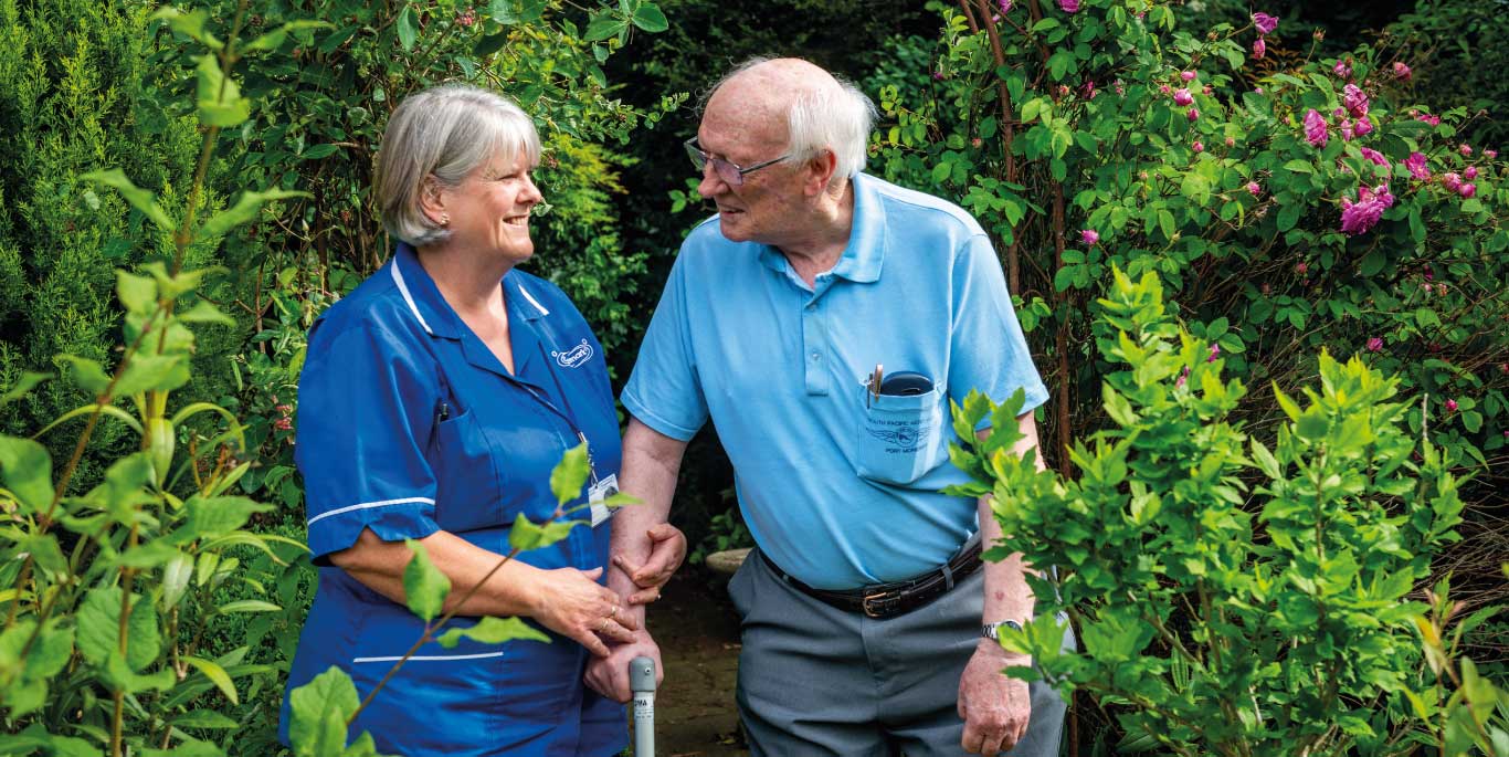 man and care assistant in the garden