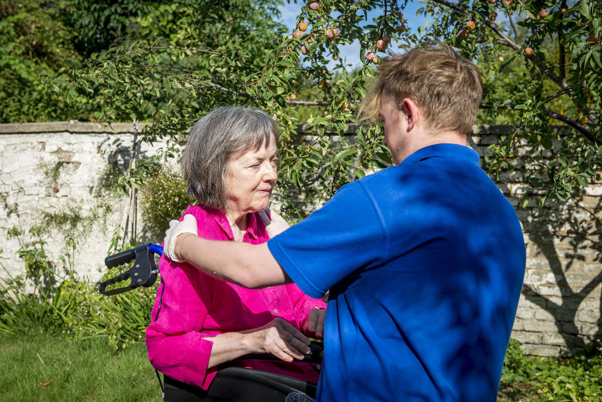 care assistant helping customer in the garden