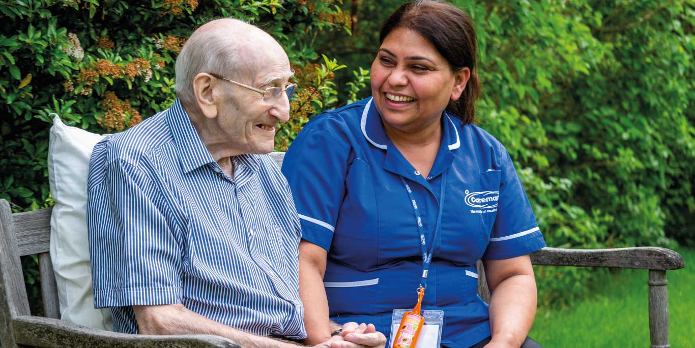 man with care assistant smiling