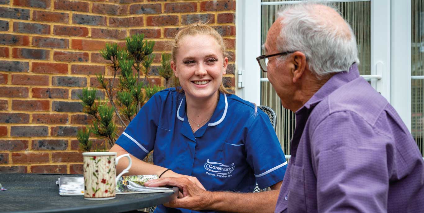 Dementia Care in Nuneaton & Bedworth : female care assistant with male customer smiling