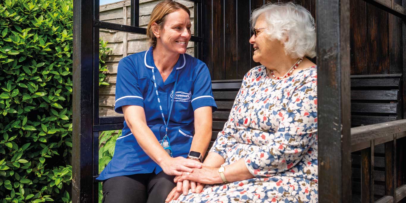 care assistant and customer holding hands