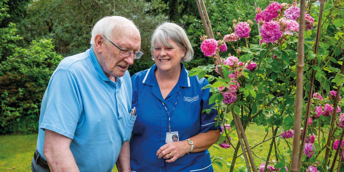 Companionship Care in Nuneaton & Bedworth Female care assistant and male customer in garden