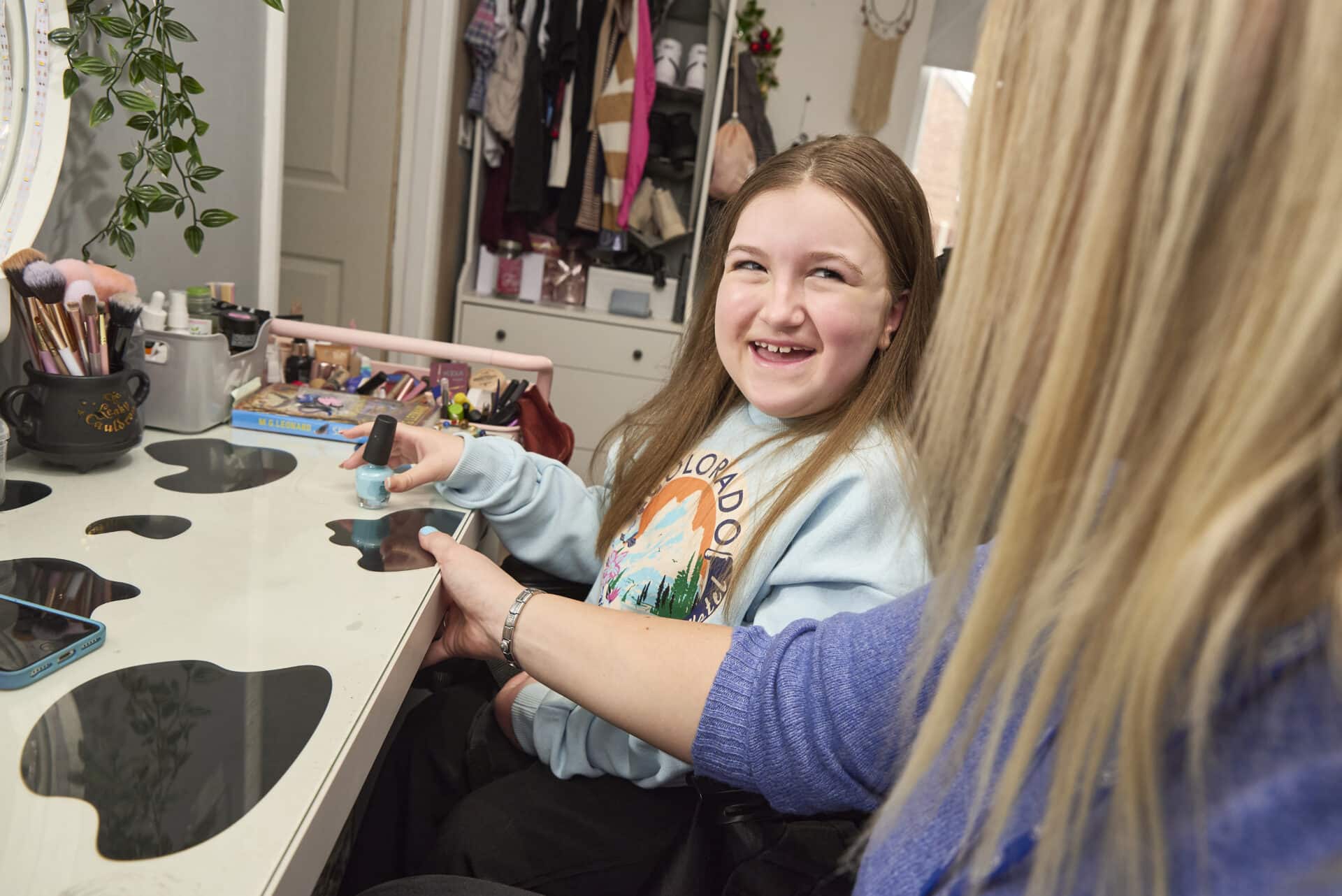 care assistant and child painting nails