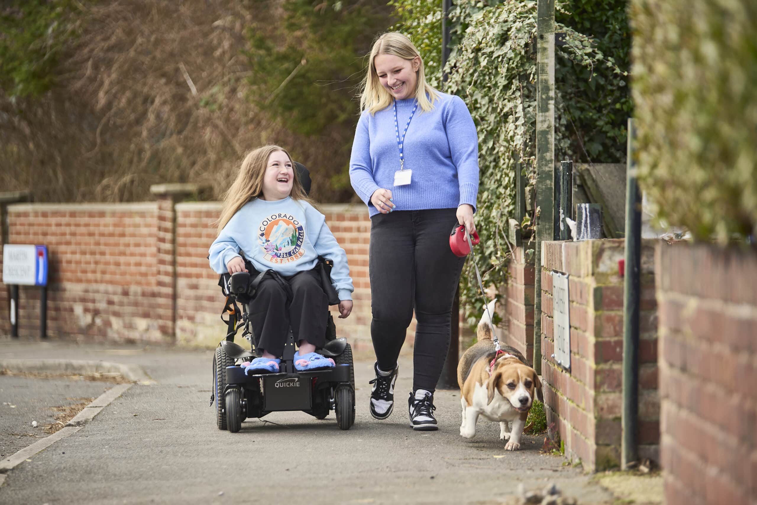 home care in milton keynes - care assistant and child going for a walk 