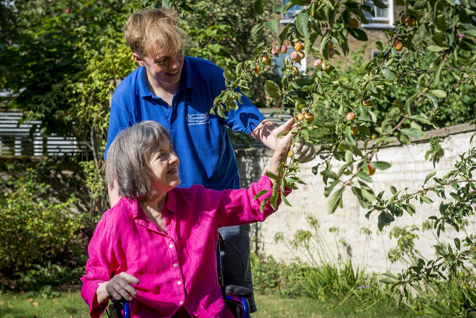 care assistant and customer picking fruit