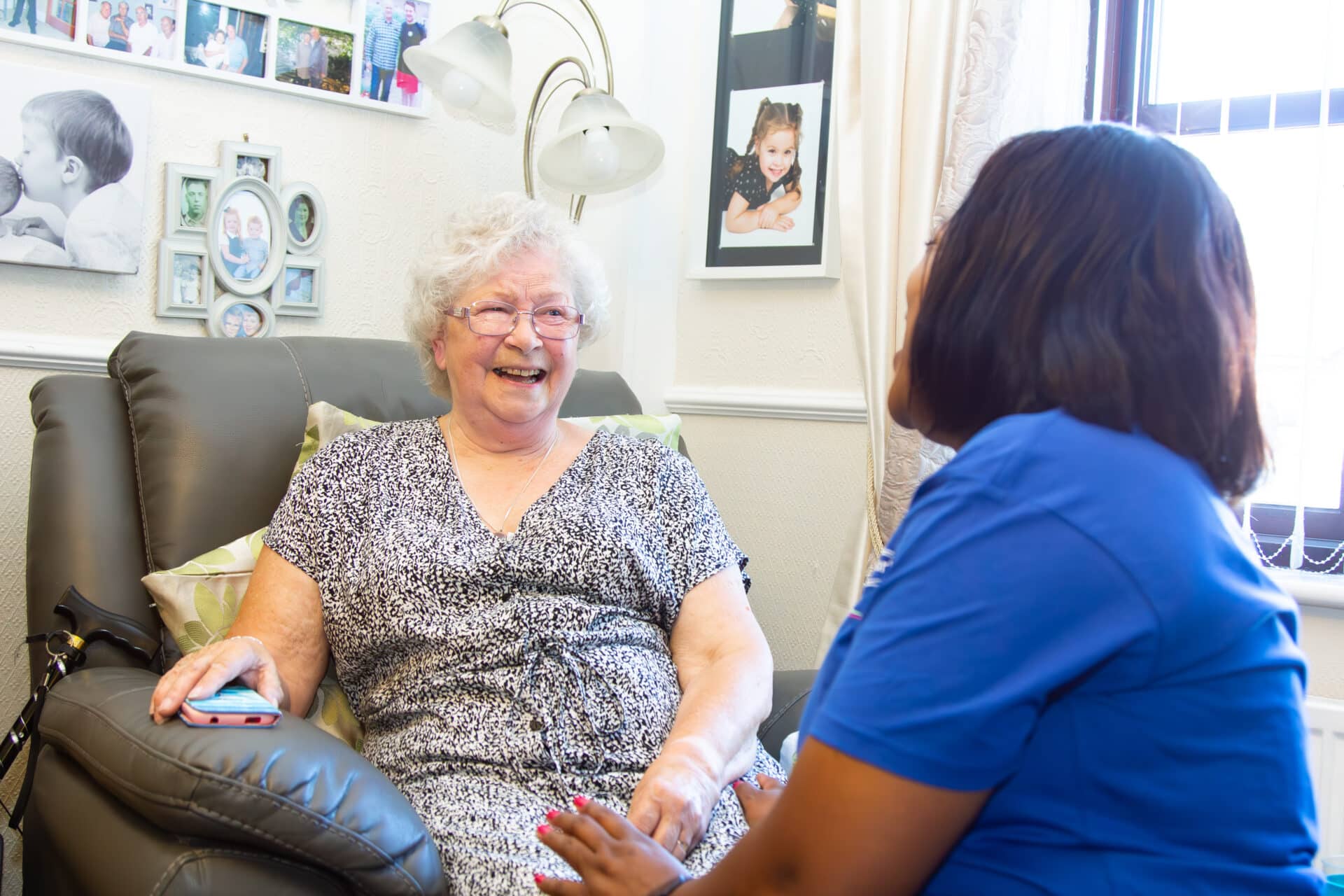 Domiciliary Care in Stratford Upon Avon : customer looking at memories : female customer at home with her female care assistant