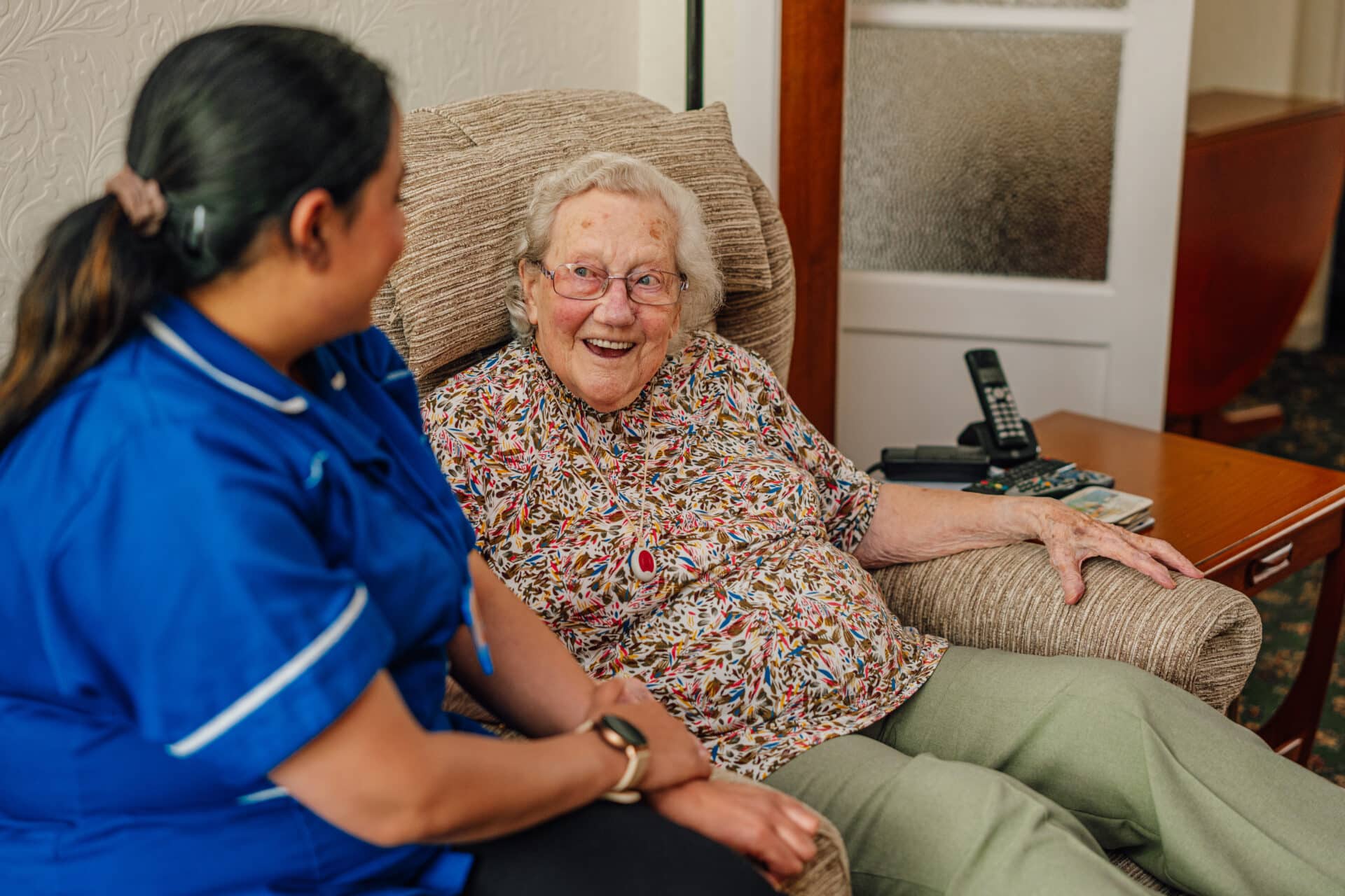 Home Care in Solihull - customer very happy sitting talking to a carer.