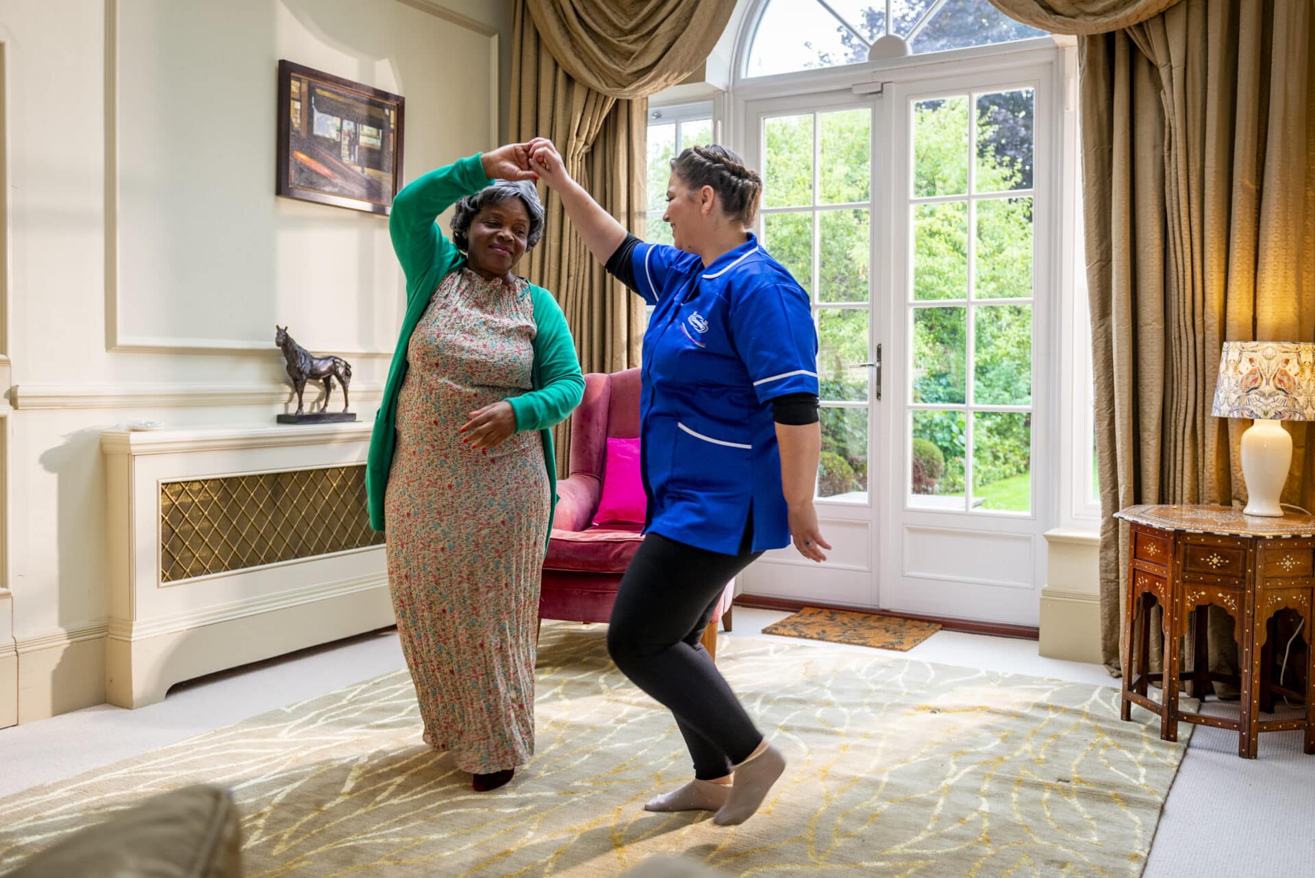 Dementia Care in Stratford Upon Avon : care assistant dancing with customer