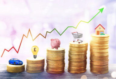 Image illustrating the cost of living crisis with a symbolic stack of coins. The coins feature images of a piggy bank, representing savings, a light bulb, representing utility costs, and a car, symbolizing transportation expenses. This visual conveys the financial challenges individuals face in managing essential expenses during times of economic strain