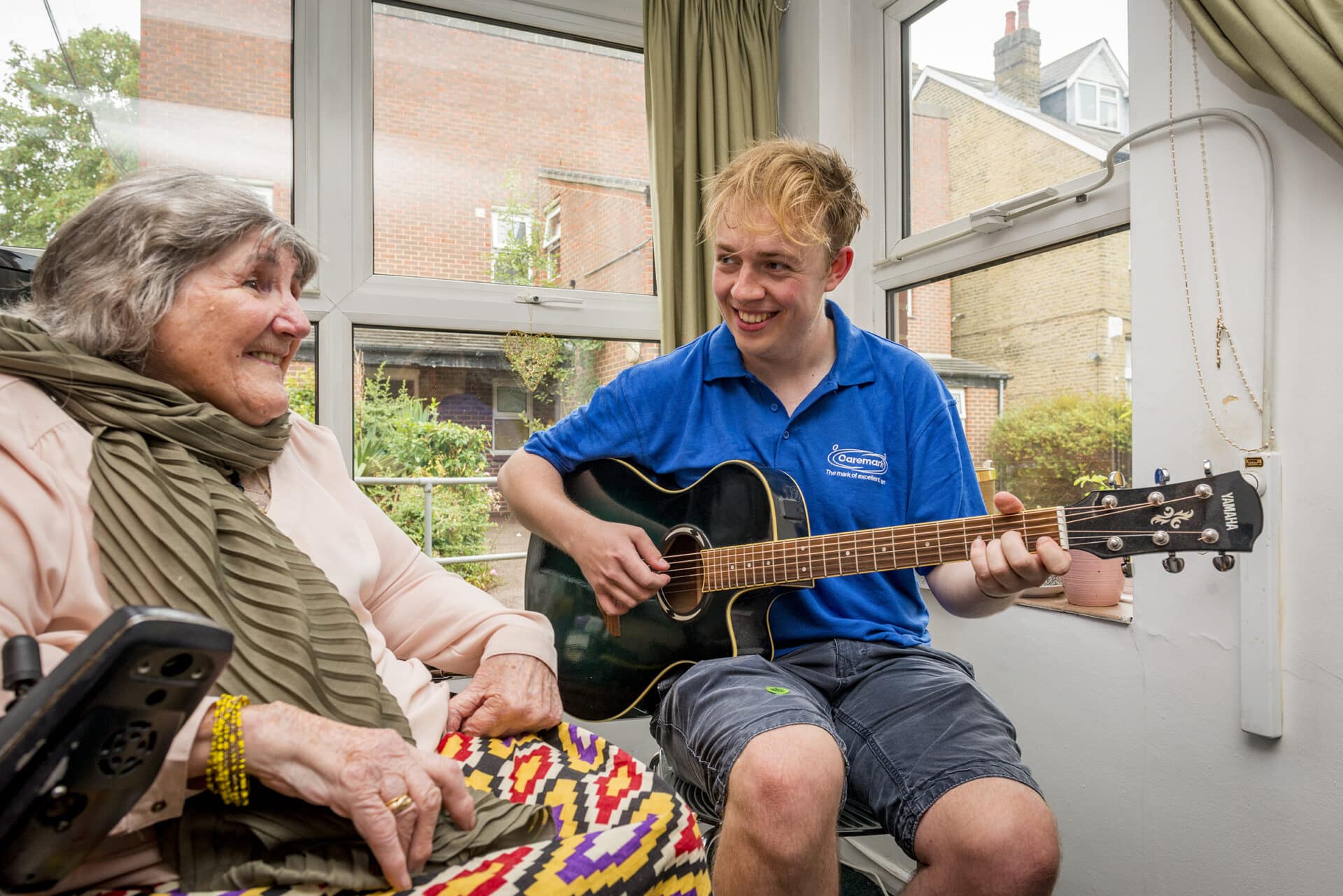 home care in redbridge: care assistant playing the guitar