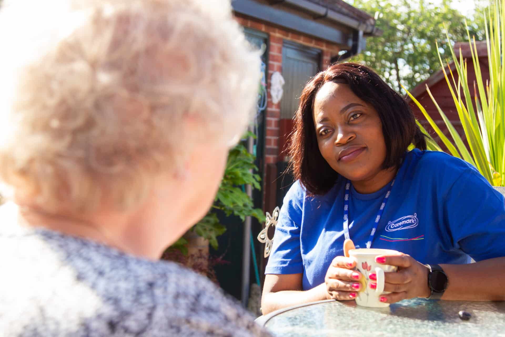 Care Assistant listening to her customer