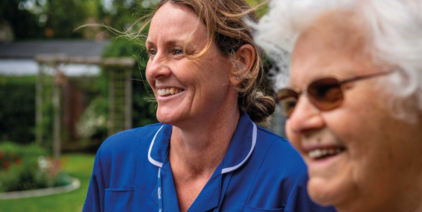 Care assistant with woman smiling