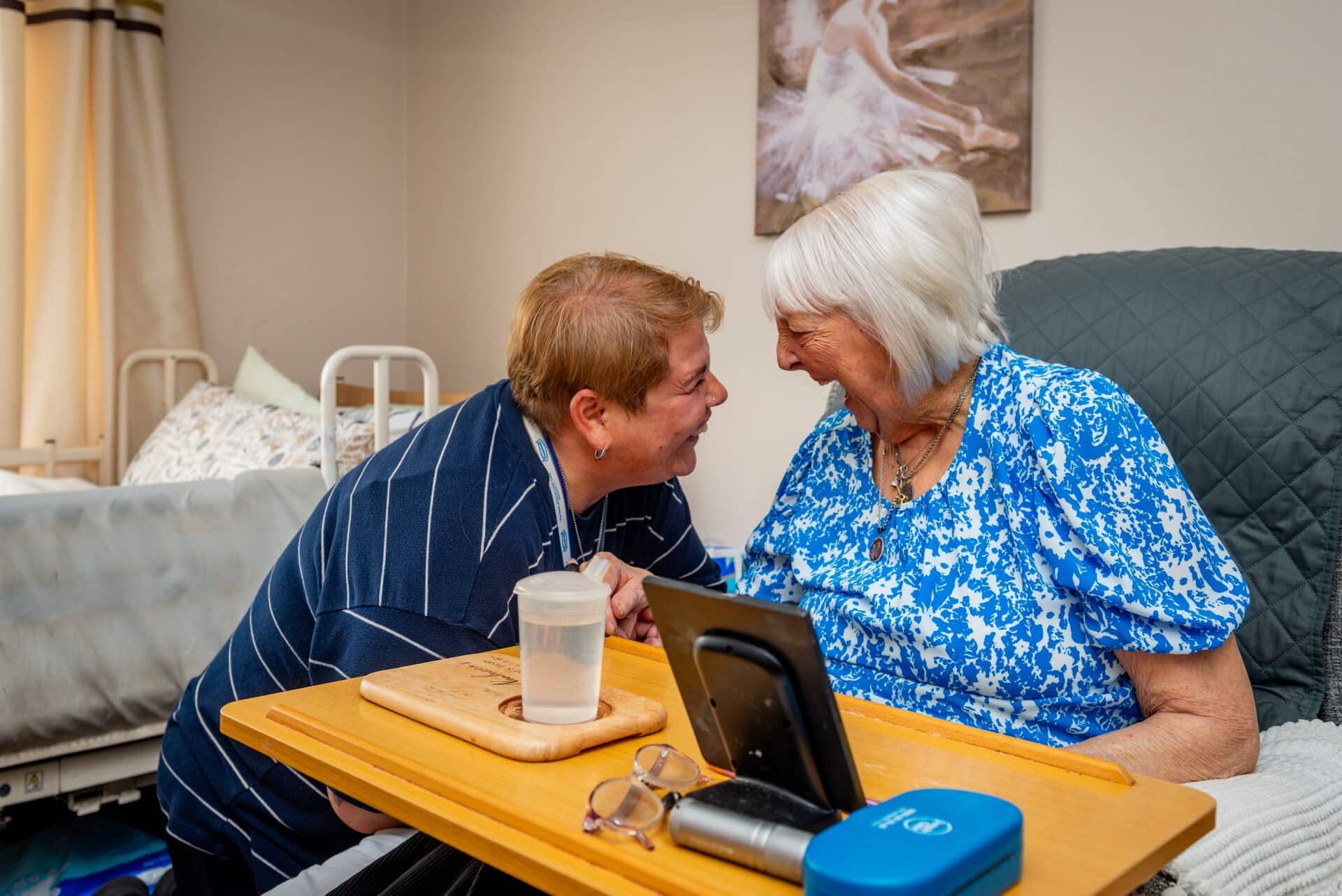 Caremark North Herts and Stevenage live-in care assistant helping an elderly client at home with daily activities and companionship.