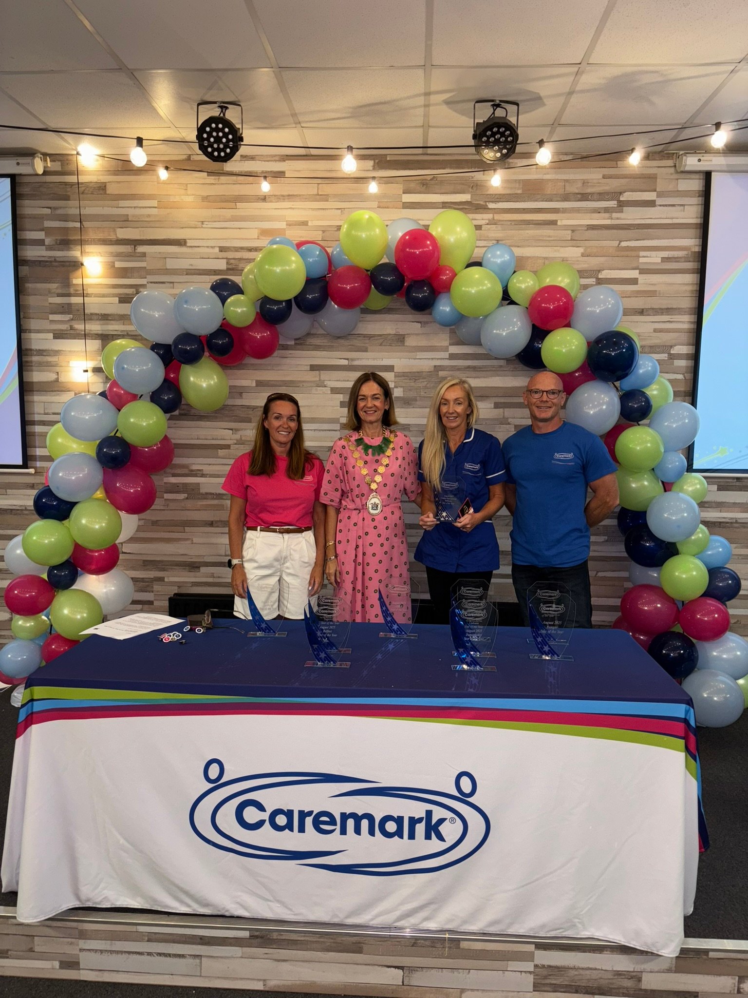 Our Comber, Ballygowan and Killinchy award winner smiling and holding her award - Caremark NI Annual Staff Awards Day 2025