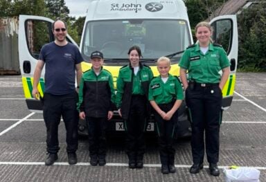 St John’s Ambulance volunteers standing in front of their ambulance at the Caremark NI family fun day