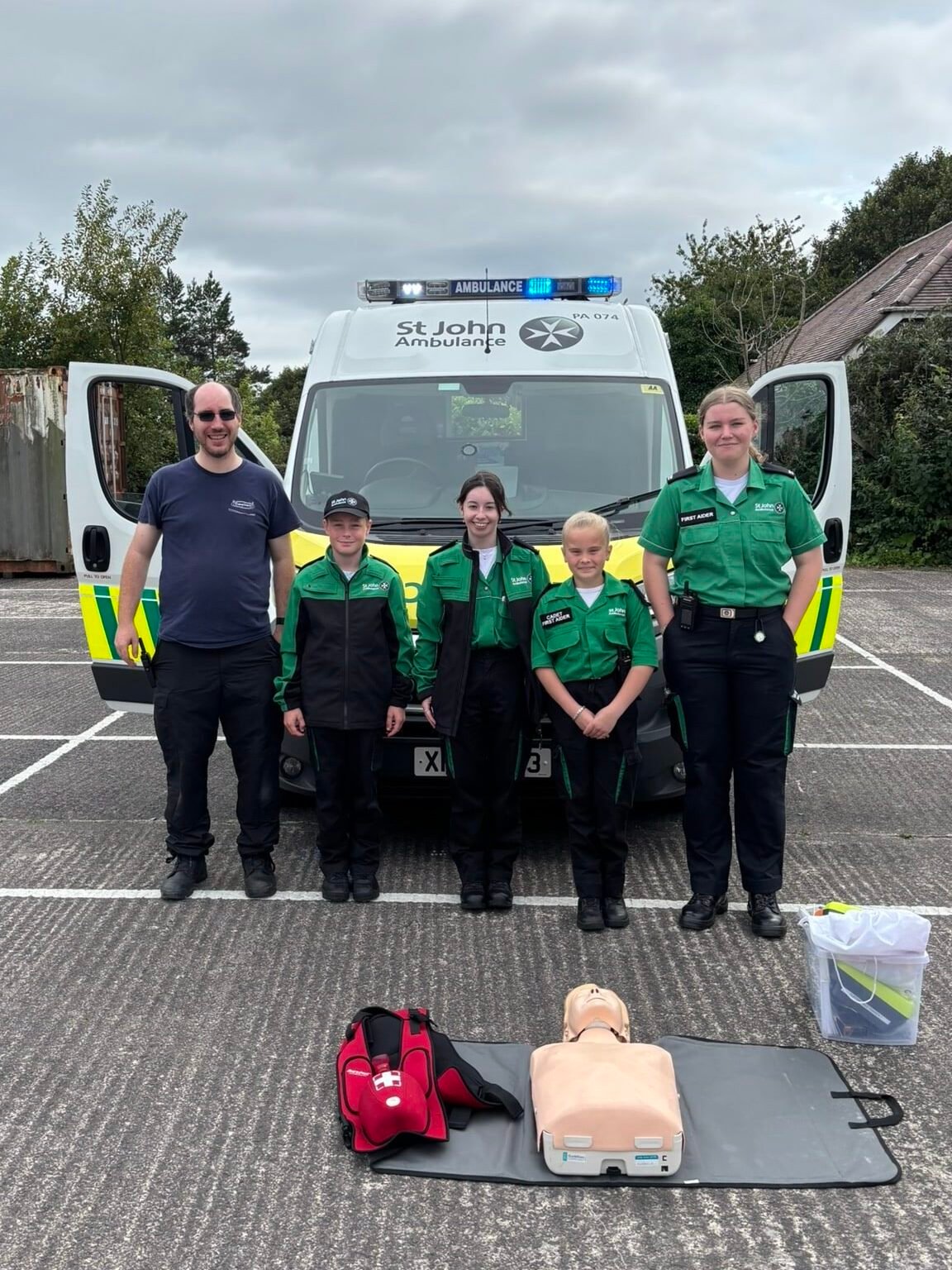 St John’s Ambulance volunteers standing in front of their ambulance at the Caremark NI family fun day