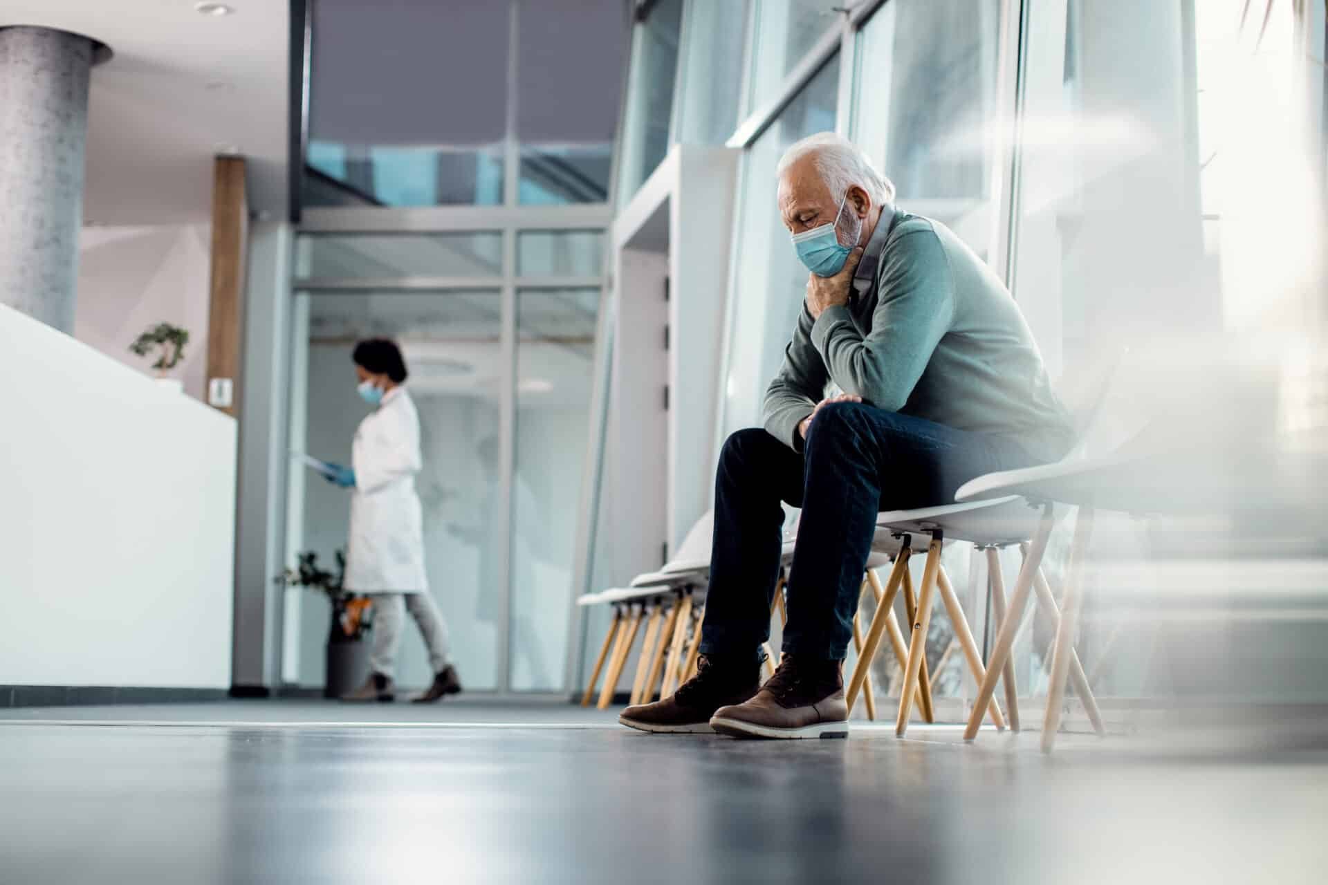 Worried elderly man in hospital waiting room