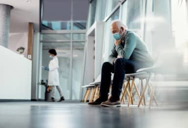 Worried elderly man in hospital waiting room