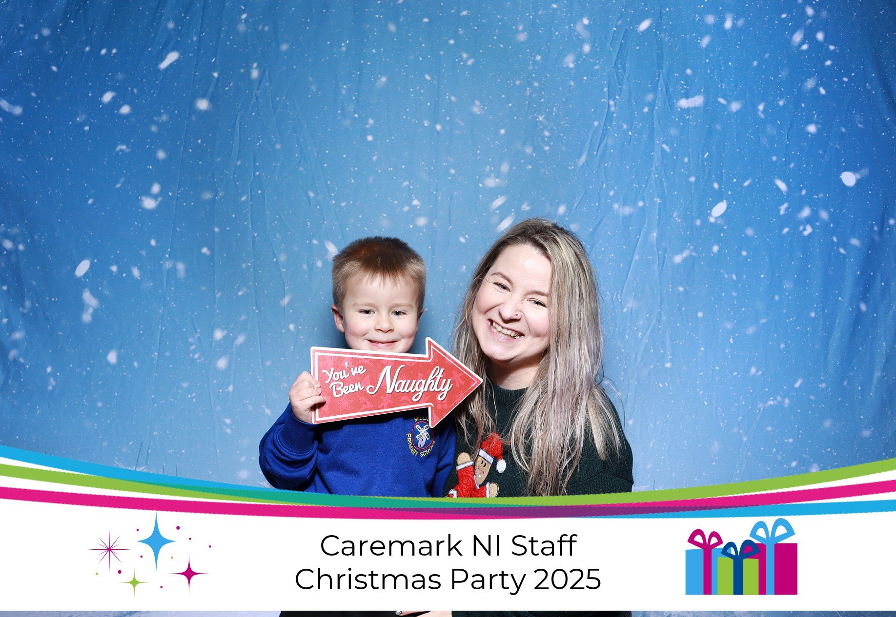A little boy and a woman smiling together in a photo booth
