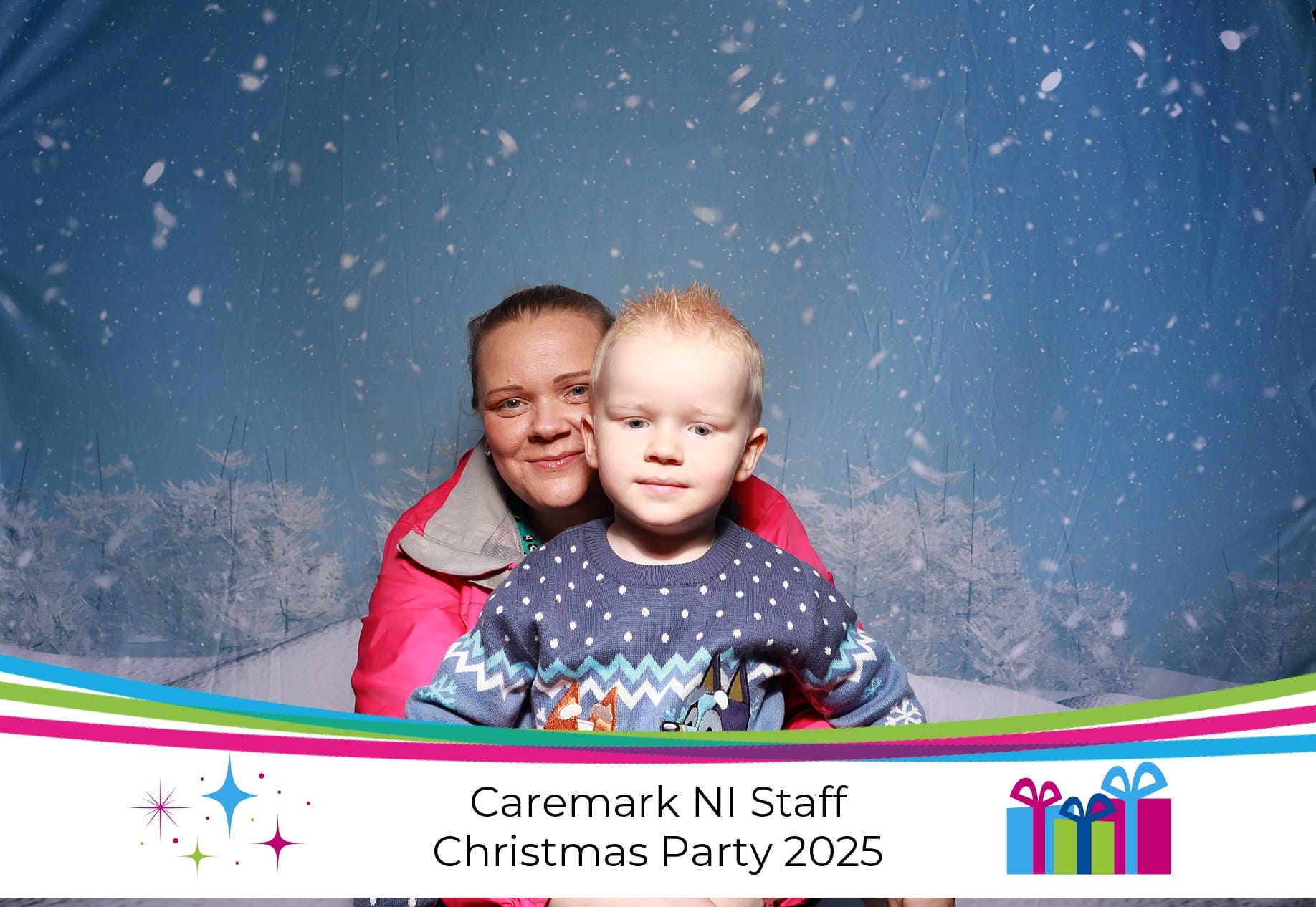 A mother and her son smiling together in a photo booth
