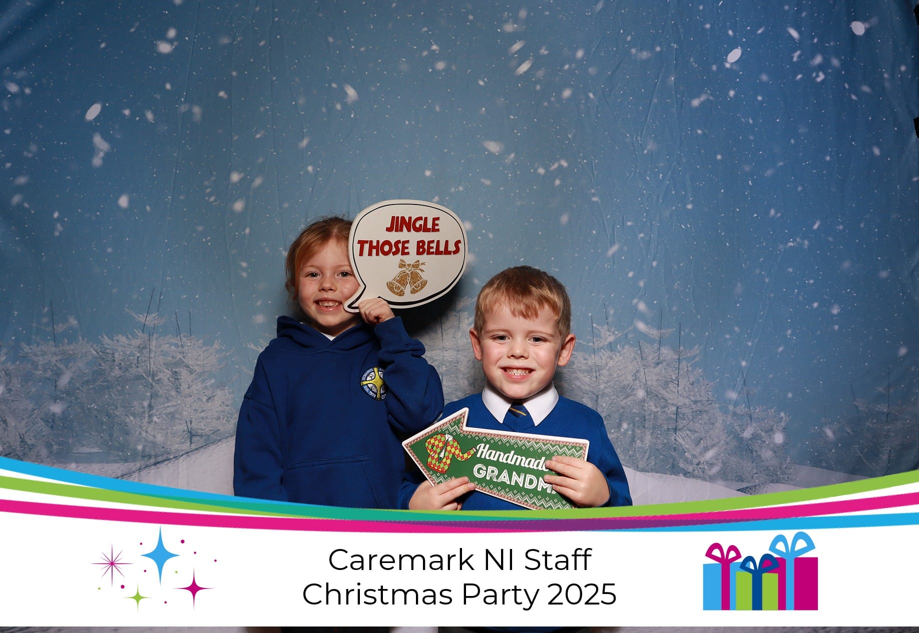 A brother and sister smiling together in a photo booth