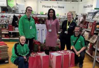 Caremark North Herts and Stevenage Marketing Manager Sharon Stevens delivering christmas gifts to staff at Dunelm Stevenage for the Delivering Joy 2025