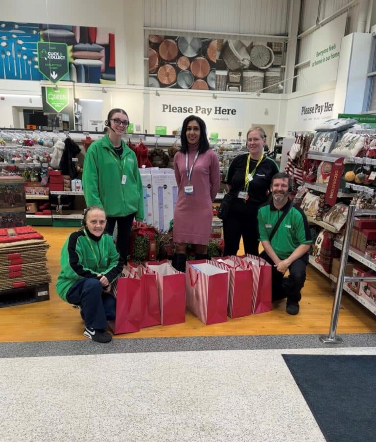 Marketing Manager Sharon Stevens of Caremark North Herts and Stevenage delivers gift bags to Dunelm Stevenage. Staff at the store took the opportunity to take a photo
