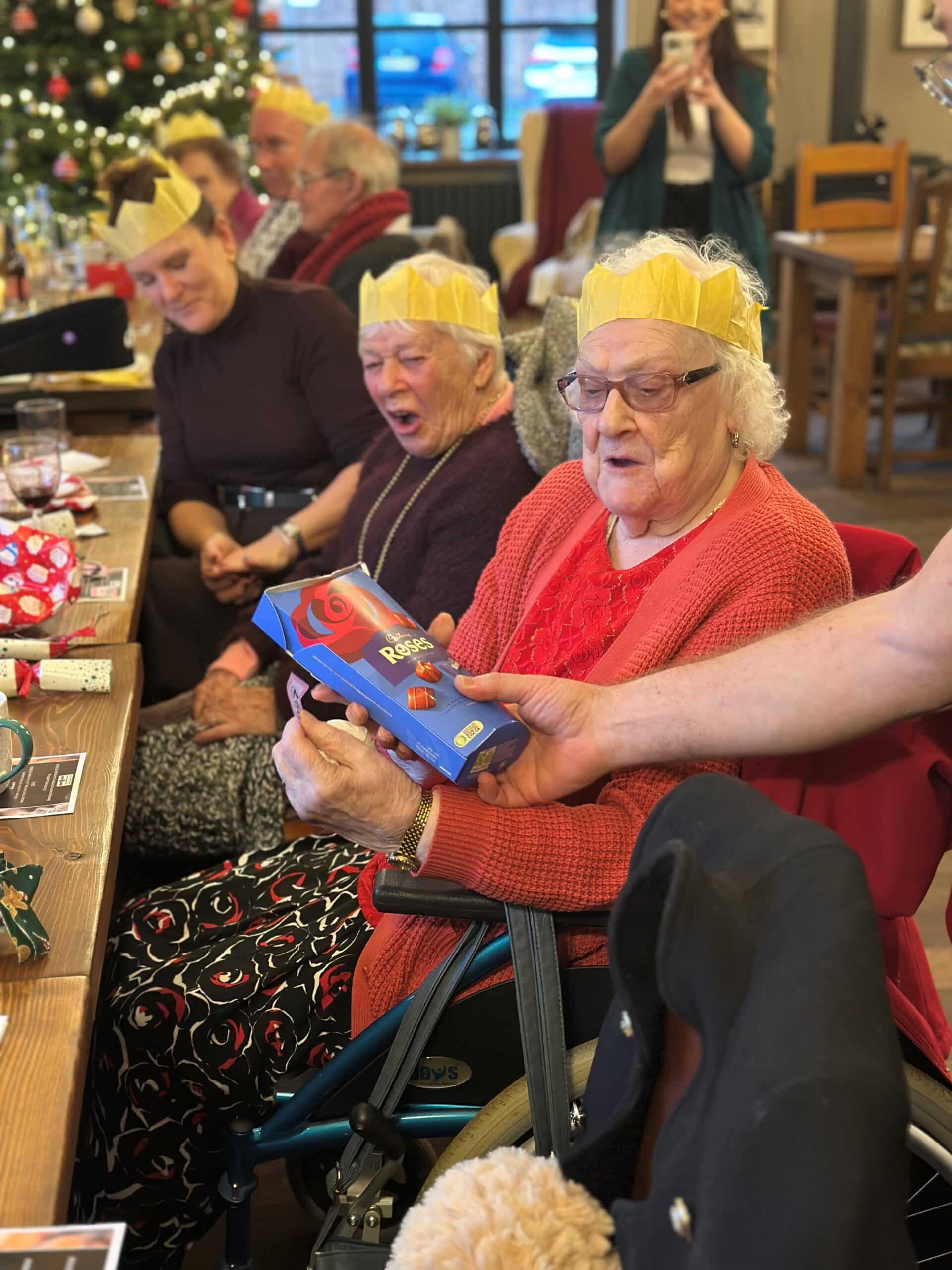 Caremark North Herts and Stevenage client receiving her prize for a winning raffle ticket at The Woodman Inn community lunch