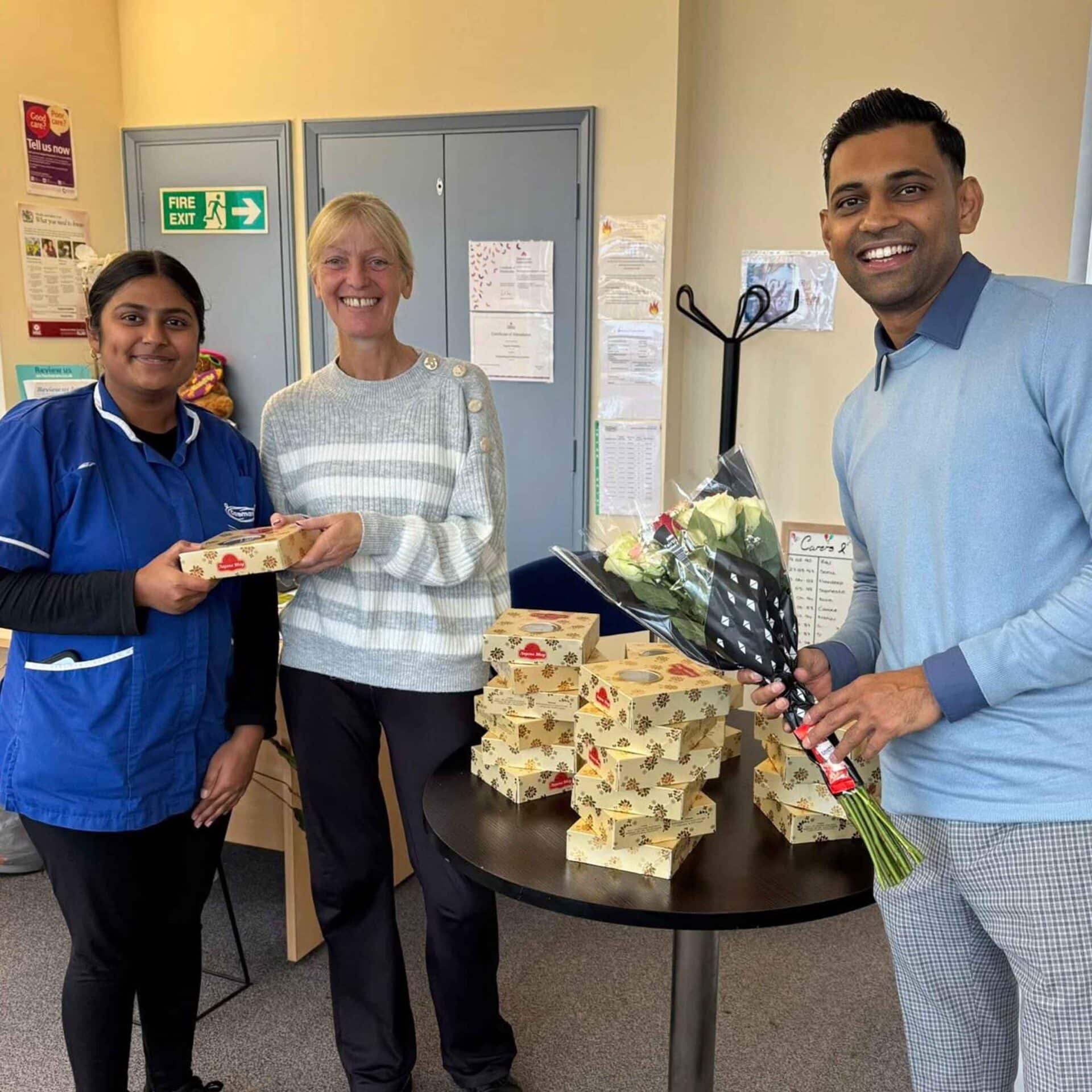 Dev from Caremark Surrey Heath and Rushmoor presenting gifts to a care customer and care professional at the office.