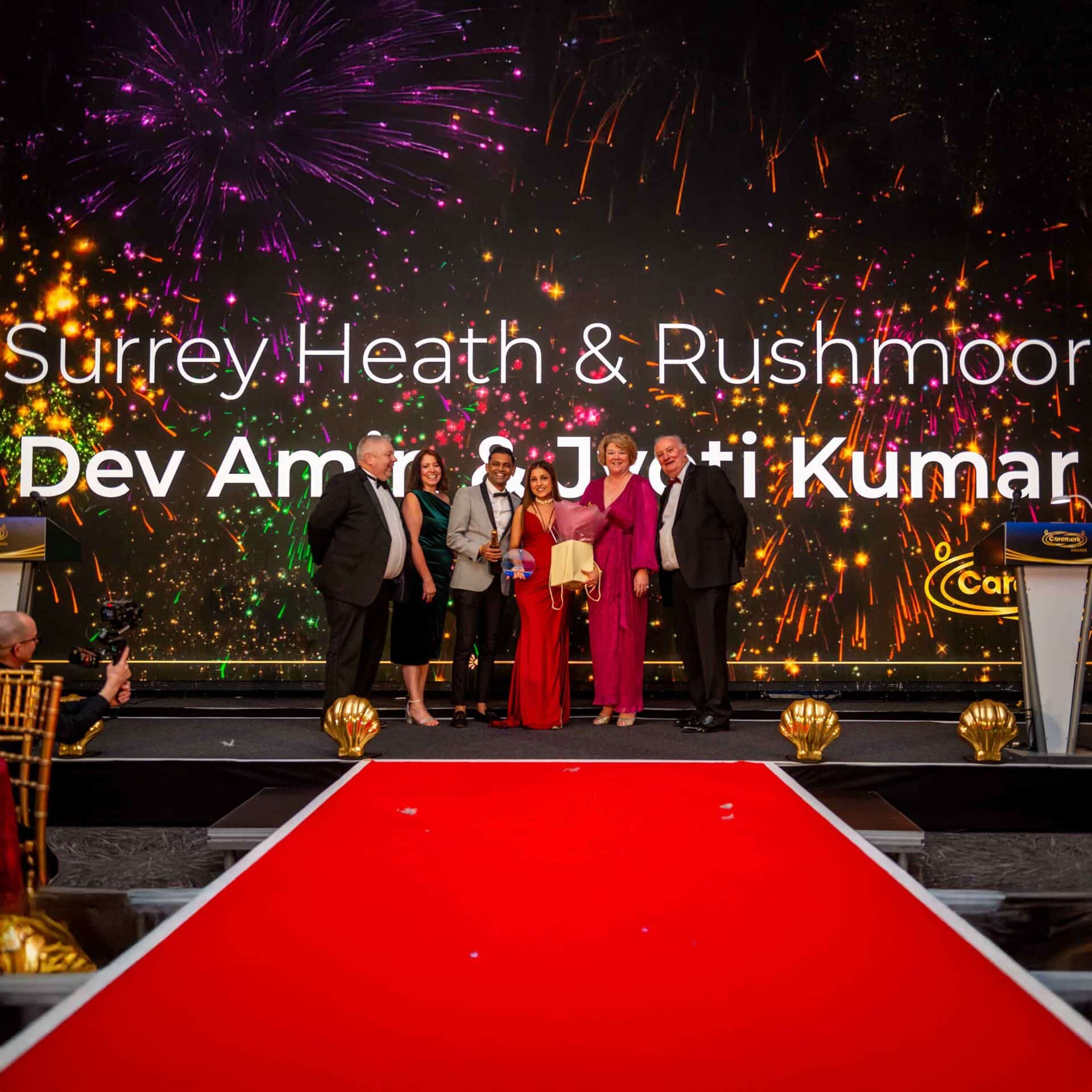 Dev and Jyoti from Caremark Surrey Heath and Rushmoor on stage at the Caremark conference awards ceremony.