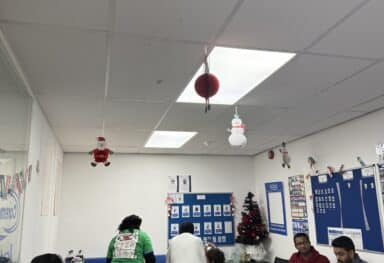 Caremark Liverpool team enjoying food and celebrating together at the Caremark Liverpool Christmas Party, showcasing festive spirit and team appreciation.