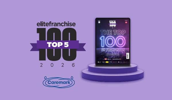 Caremark ranked number 5 in the Elite Franchise Top 100 2026 against the biggest UK franchises. The ranking is shown on a purple podium graphic with the Top 100 UK Franchises magazine cover.