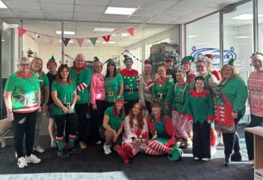 Office staff dressed up as elves for Caremark NI’s Elf Day