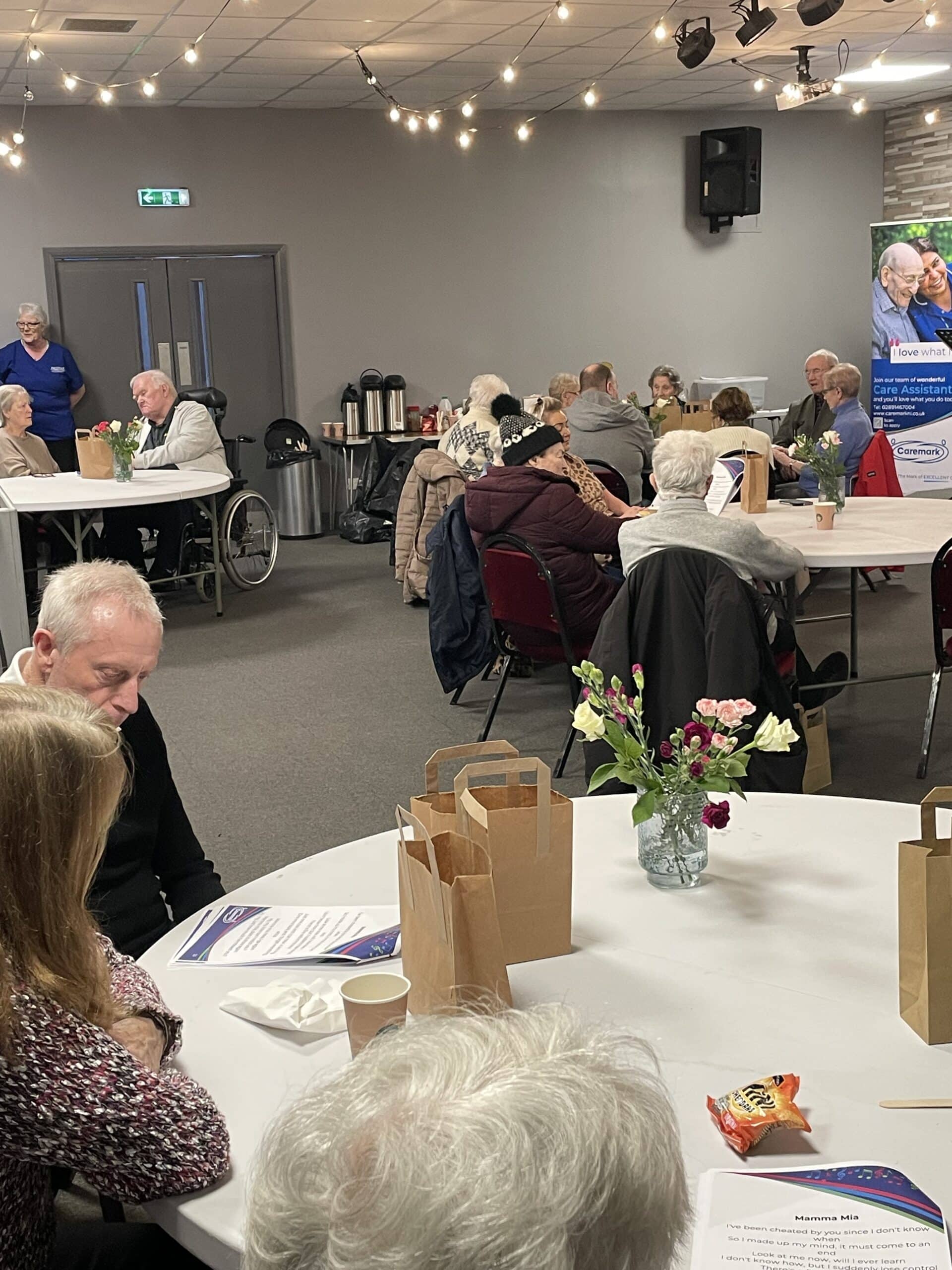 photo of room filled with service users sitting at the tables