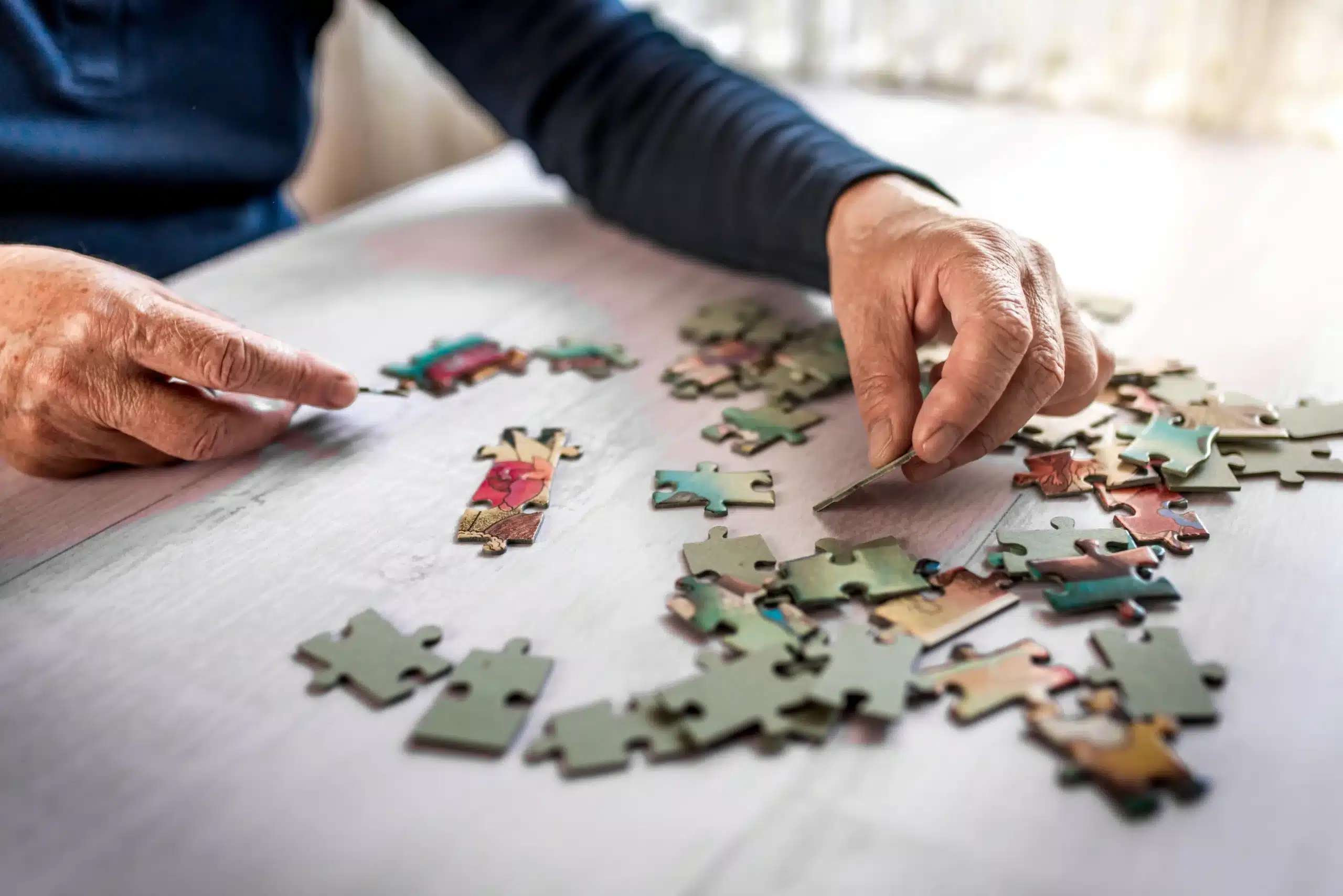 Dementia patient doing a puzzle to help stimulate memory