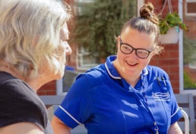 Dementia communication with smiling female care assistant